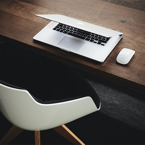 An apple laptop on a wood table after a business consulting session